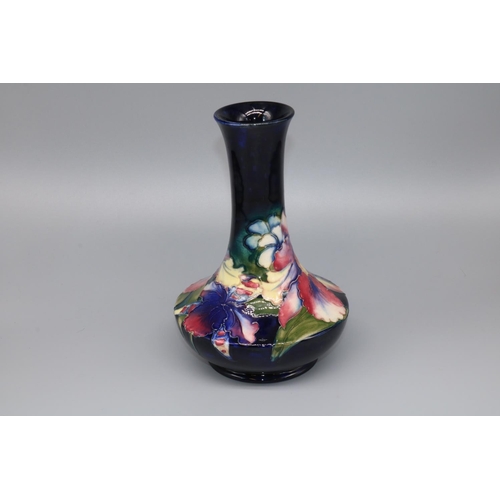 1148 - Moorcroft Pottery: Orchid pattern vase, compressed form with waisted neck, tubelined decoration of p... 