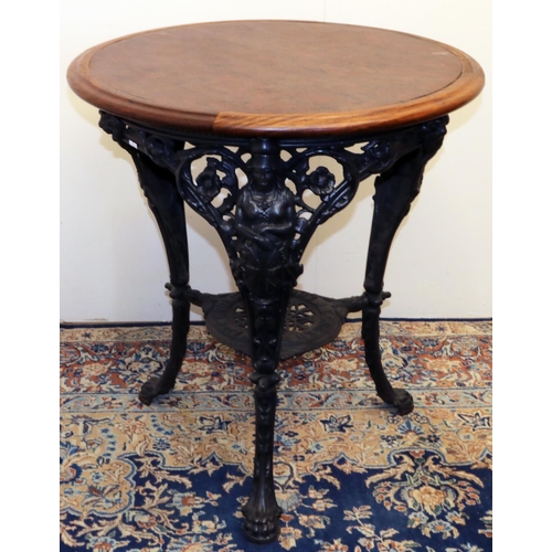 1398 - T. Green & Son Ltd. London & Leeds - a cast iron tavern table, circular wooden top on three Britanni... 