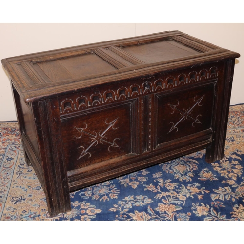 1314 - C18th oak coffer, with moulded frame, two panel top and  acrcade carved frieze above two crossed arr... 