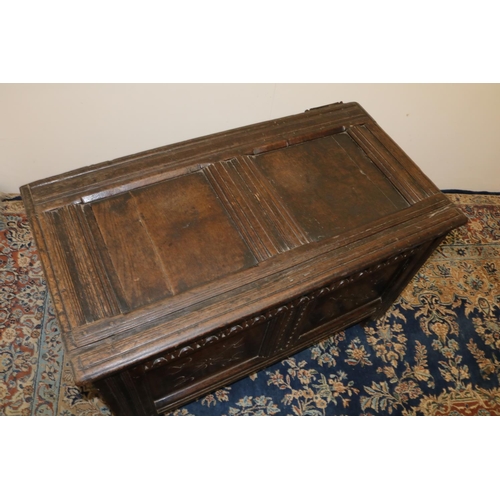 1314 - C18th oak coffer, with moulded frame, two panel top and  acrcade carved frieze above two crossed arr... 