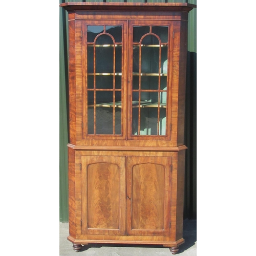 1322 - George 1V mahogany corner cabinet, stepped cornice and two astragal moulded glazed doors above two c... 