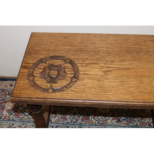 1377 - C17th style oak rectangular coffee table, moulded top carved with a Yorkshire Rose on turned and blo... 