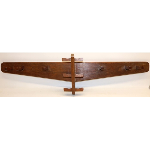 1378 - Yorkshire Oak style coat rack with twelve angular pegs on a tapered board, W107cm