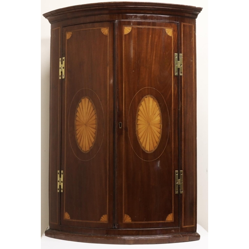 1333 - George 111 inlaid mahogany bow front corner cupboard, cavetto cornice above two boxwood strung doors... 