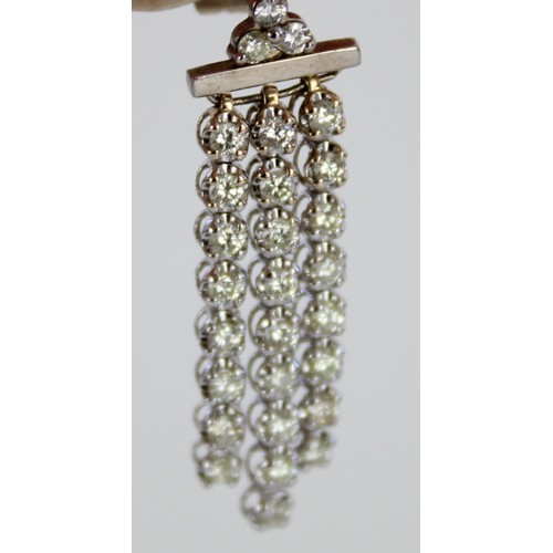 1012 - 18ct white gold diamond drop earrings, a cluster of three brilliant cut diamonds above three suspend... 