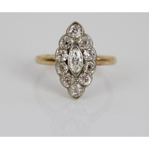 1003 - Yellow metal diamond ring, the central marquise cut diamond surrounded by a halo of round cut diamon... 