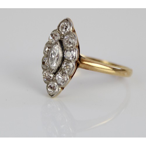1003 - Yellow metal diamond ring, the central marquise cut diamond surrounded by a halo of round cut diamon... 