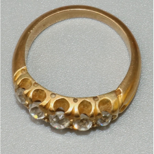 1016 - Yellow metal five stone diamond ring, the graduated brilliant cut diamonds in claw settings, on groo... 