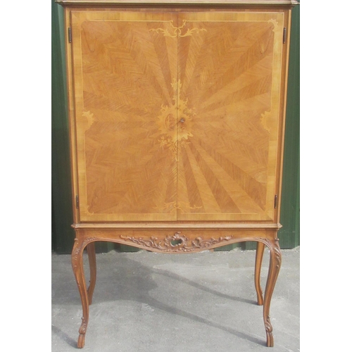 1334 - C20th Rococo Revival walnut cocktail cabinet, two sunburst and C scroll doors revealing fitted inter... 