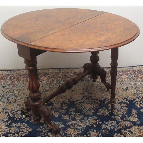 1332 - Victorian figured walnut Sutherland table, two fall leaves on fluted baluster supports and scroll fe... 