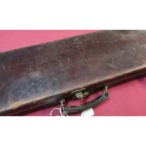 101 - Vintage leather gun case with red baize fitted interior to fit up to 30inch barrels with trade label... 