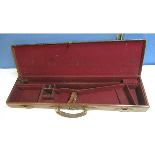 105 - C20th brown leather shotgun case, fitted red baize interior, fitted lock (no key), initialled to top... 