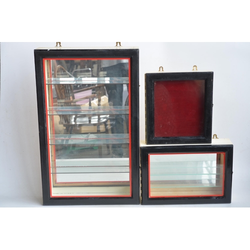 340 - Three wall hanging front opening wood and glass display cabinets to include 2 multi-shelf examples s... 