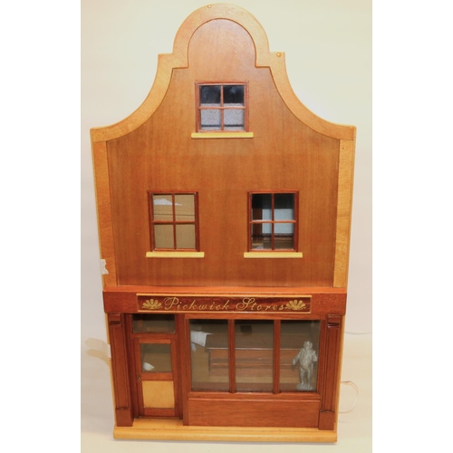 265 - Wooden dolls house in the style of of a shop with flat above, furnished with lighting and figures