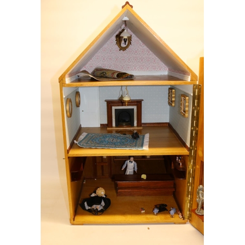 265 - Wooden dolls house in the style of of a shop with flat above, furnished with lighting and figures