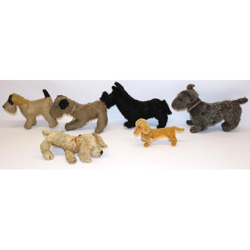 59 - Five vintage toy dogs including a Chiltern golden spaniel, and a modern Steiff dachshund