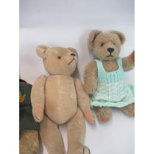 51 - Four early C20th and later British teddy bears, one in a green duffel coat