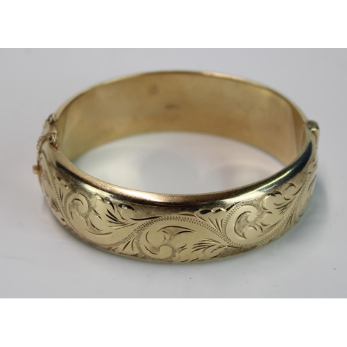 1440 - Hallmarked 9ct gold half engraved bangle with push in clasp and safety chain, 24g, internal width 5.... 