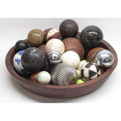 644 - C20th eastern hardwood bowl cont. various ceramic, wood, and other balls, (qty)