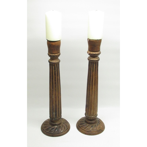 650 - Pair of C20th eastern hardwood candle stands with candles