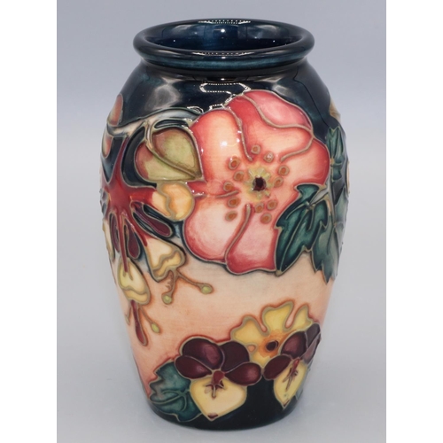 1393 - Moorcroft Pottery: Oberon pattern vase, tubelined decoration of pink and yellow flowers on a dark bl... 