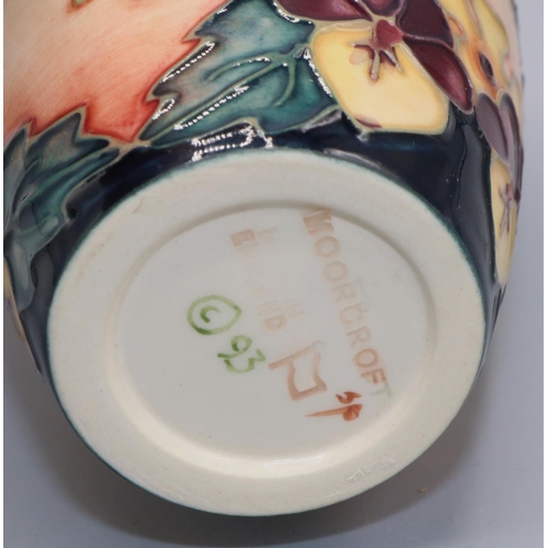 1393 - Moorcroft Pottery: Oberon pattern vase, tubelined decoration of pink and yellow flowers on a dark bl... 