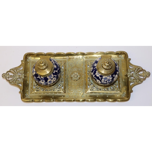 585 - Late C19th brass inkstand, fitted with twin globular porcelain wells decorated with blue and white p... 