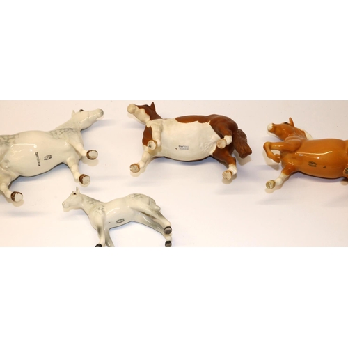 639 - Four Beswick horses: Skewbald Pinto pony No. 1373 in matt finish, Prancing Arab No. 1261 in palomino... 