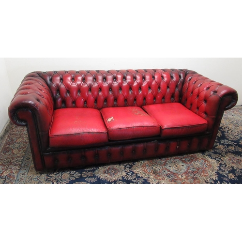 671 - Red leather Chesterfield sofa with deep buttoned back and arms, three seat cushions, W193cm