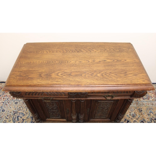 541 - Edw. VII Gothic revival oak side cabinet, moulded top over two frieze drawers and two panelled doors... 