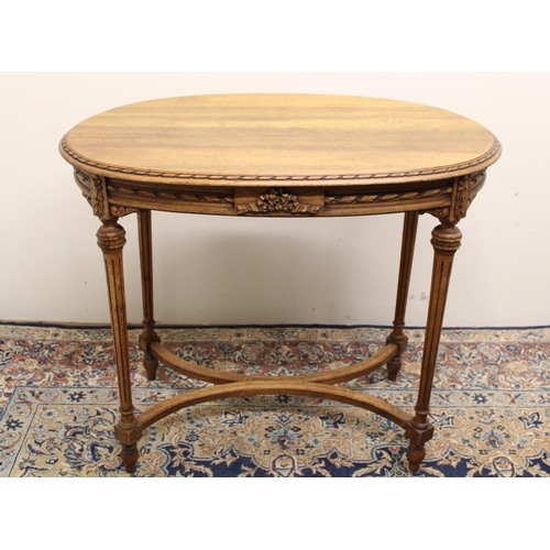 542A - French oak oval occasional table with decorated frieze on turned and fluted tapering legs with X-sha... 