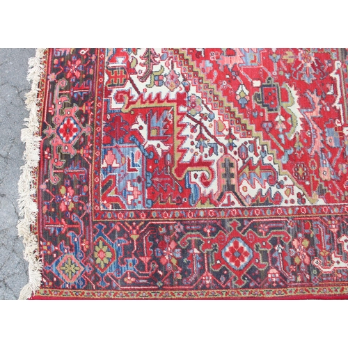 549 - C20th Belgian Louis Poortere Heriz pattern red ground rug, 344cm x 241cm