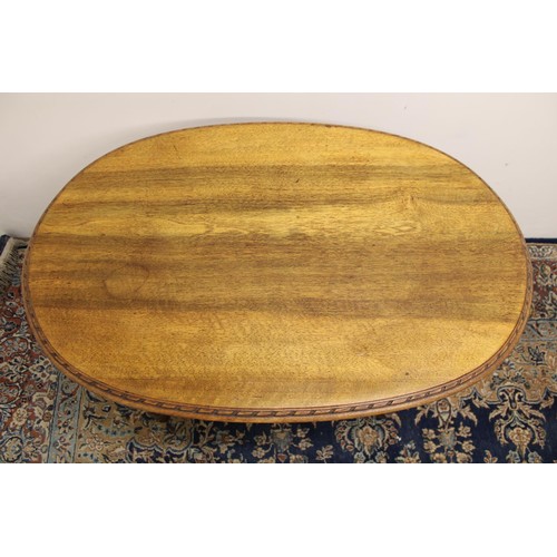 542A - French oak oval occasional table with decorated frieze on turned and fluted tapering legs with X-sha... 