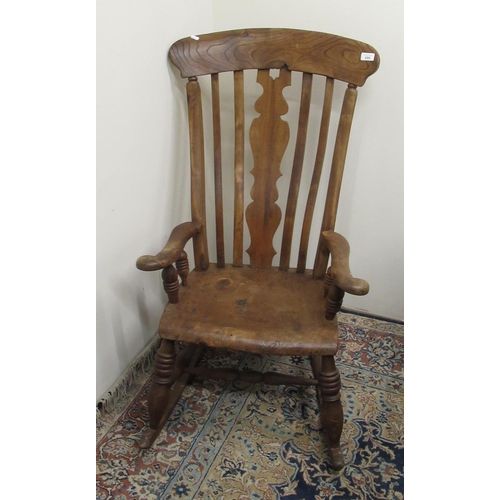 686 - C19th elm and beech lath back farmhouse rocking chair with shaped central splat, scroll arms and tur... 