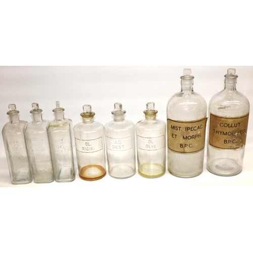 732 - Collection of eight various Apothecary or Chemists clear glass bottles, titled in white and on paper... 