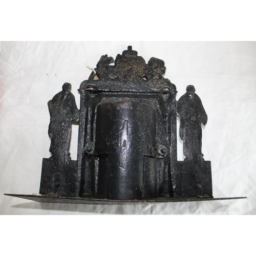 226 - Victorian black painted iron hearth ornament, cast as a fire place with two figures and Royal crest,... 