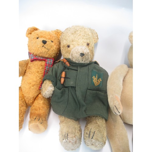 1345 - Four early C20th and later British teddy bears, one in a green duffel coat (4)