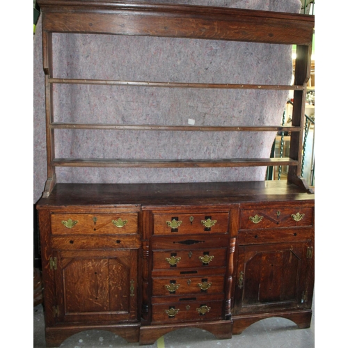 276 - Geo.1V oak breakfront dresser, with six drawers and two doors with brass handles on bracket feet, la... 