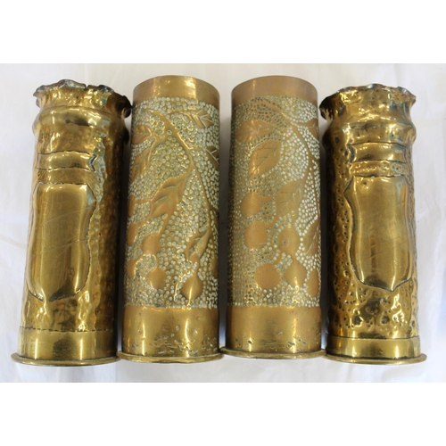 678 - Pair of Trench Art artillery vases with floral and fruit design, pair with shield and swag design st... 