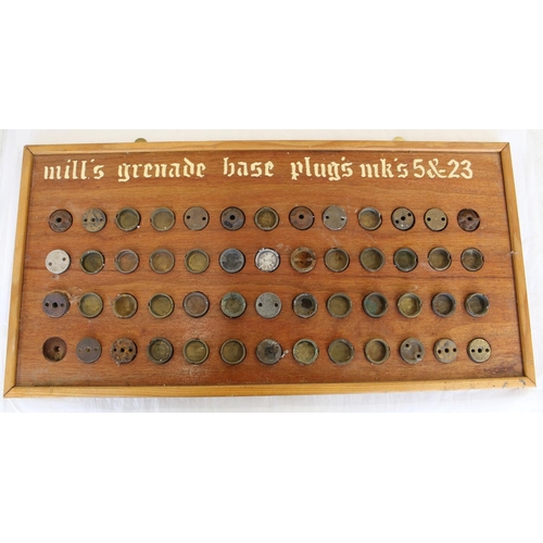 689 - Framed collection of Mills hand grenade plugs. Mk 5& 23 various dates (51). Frame 69cmx34cm