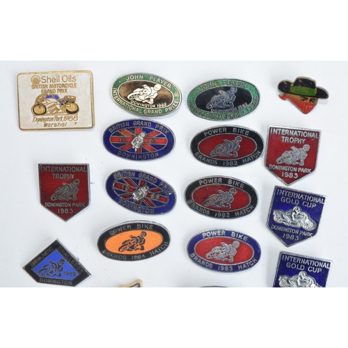 199 - Twenty three motorbike racing related pin badges to include 20 enamel badges for the British Grand P... 