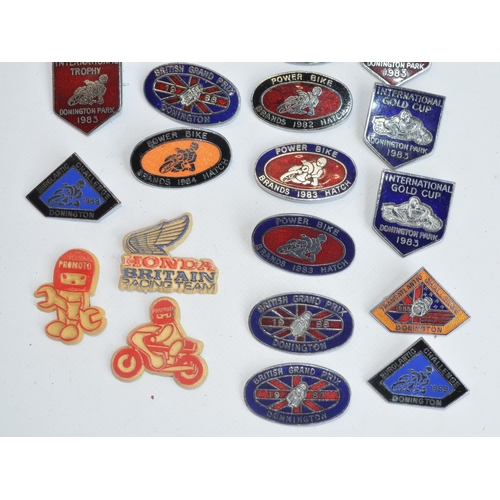 199 - Twenty three motorbike racing related pin badges to include 20 enamel badges for the British Grand P... 