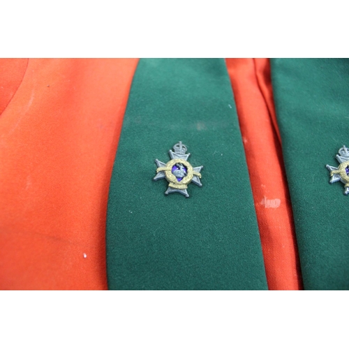 725 - Officers Mess Jacket in red and with green lapels and cuffs. green matching waistcoat. Rank of Capta... 