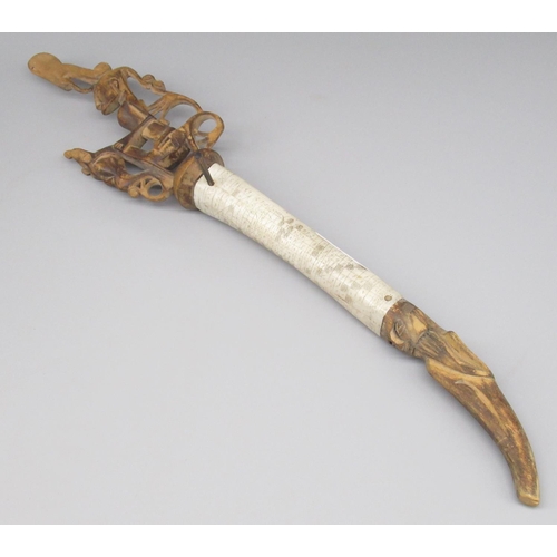 643 - Indonesian bone and hardwood blow dart holder, with ornate 'scrimshaw' work to bone body and figural... 