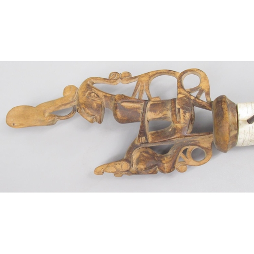 643 - Indonesian bone and hardwood blow dart holder, with ornate 'scrimshaw' work to bone body and figural... 