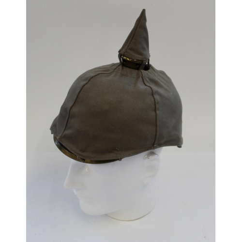 712 - Reproduction Prussian Pickelhaube. Black leather with brass spike and eagle plate. Complete with kha... 