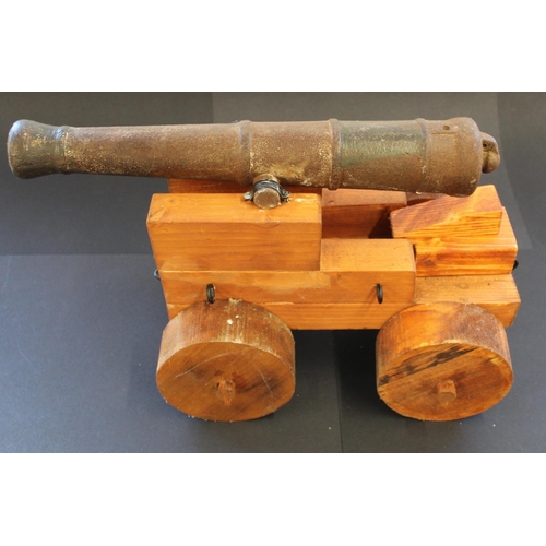 761 - Cast iron model cannon. The carriage is a replacement. Barrel length 16ins. 41cm