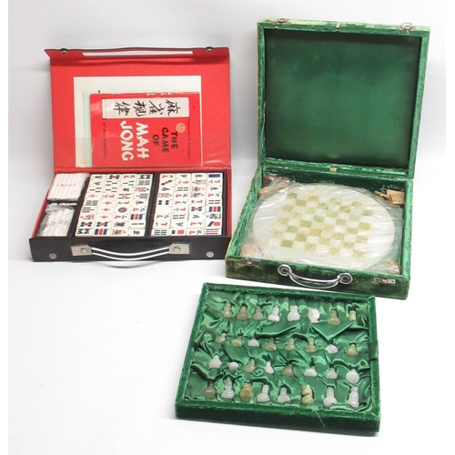 60 - Cased green and milky-white chess set with circular board, and a cased Mahjong set (2)