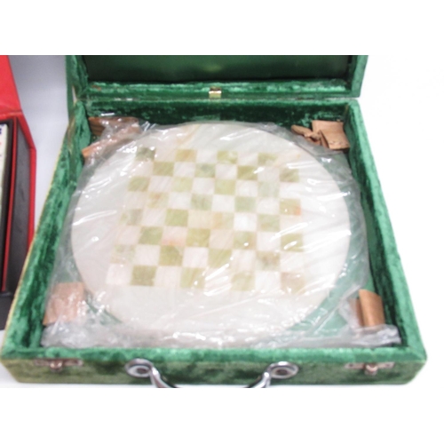 60 - Cased green and milky-white chess set with circular board, and a cased Mahjong set (2)