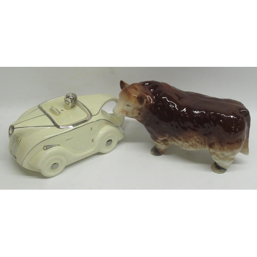 777 - Sadler Regd. No. 320236 cream car teapot and a Beswick style model of a cow (2)